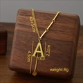 Titanium steel gold necklace with letter A pendant and rectangle links on walnut wood - Letter A / Gold