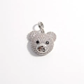 Macro shot of silver teddy bear pendant with sparkling white and black zircon stones - Platinum White Zirconia