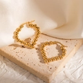 Detail of gold plated heart shaped beaded earrings on beige stone and silk background - Heart-Shaped Metal Bead Hoop