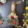 Detail of decorative holiday broom with dried red roses, crystals and natural twine wrap - Broom+Flowers+Light Amethyst