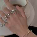 Close-up of gothic silver skull and bat rings set worn by model with chain bracelet - Heart Chain Silver Set (55387)