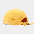 Detail of yellow canvas brimless docker cap featuring white 'absolutely not.' embroidery - Adjustable / Yellow