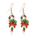 Macro detail of Christmas candy cane earrings with red bow and green holly accents - Pink Unicorn