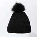 Detailed view of the thick ribbed knit texture and soft faux fur pom-pom on the black beanie - Black