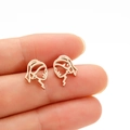 Macro shot of rose gold Girl with a Pearl Earring hollowed-out face profile stud earrings - Rose Gold