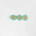 Detail of three mint green knit flower hair clips on a white fabric-wrapped barrette - Mint Green