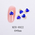 Detail of 6x8mm heart-shaped blue nail rhinestone with gold base on false nail - Gold Heart Style With Blue Crystal (8922)