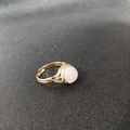 Detail of handmade gold wire-wrapped ring featuring a round frosted pink crystal stone - Adjustable Open / Rose Quartz