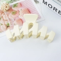 Matte cream white wavy hair claw clip for women shown in a lifestyle setting - Off White