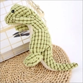 Green pineapple fleece crocodile dog toy for chewing and interaction shown on a basket - Light Green Dinosaur