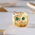 Macro detail of golden brushed cat head ring with green gemstone eyes and tiny diamonds - Adjustable Open / Style 4-Brushed Gold Cat Head with Green Eyes