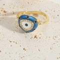 Detailed view of adjustable golden evil eye ring with blue enamel and sparkling zircon - Royal Blue Triangle Ring