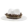 Close-up of white woven straw fedora hat featuring brown feather and gold skull chain - M (56-58cm) / White