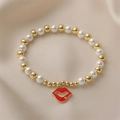 Golden bead and white pearl bracelet featuring a red lips enamel pendant with rhinestone - Red Lips Enamel With Diamond Pendant
