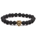 Lava stone beaded bracelet featuring a finely detailed golden metal lion head charm - Lava + Gold