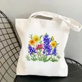 White canvas tote bag featuring colorful wildflower garden print on a metal chair - C12 Sunflower Watercolor Floral