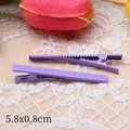 Detail view of two 6cm purple metal duckbill hair clips on beige lace with tulips - Purple