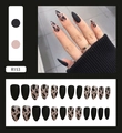 Detail view of R153 matte almond press-on nails with black and cow print designs - Black Leopard Pointed Matte Style (R153)