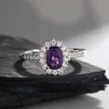 Macro shot of oval amethyst ring with halo of white zircons on natural stone background - Pavé White Zircon Style (LR305)