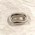 Minimalist silver oval metal elastic hair tie accessory on textured white paper - Silver