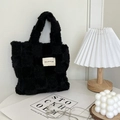 Detail of black fuzzy checkerboard tote bag with woven label in cozy indoor setting - Black Checkerboard