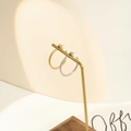 Macro shot of gold and silver textured hoop earrings on a minimalist display stand - 20mm / Gold