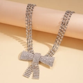 Detailed macro view of triple-layered silver choker necklace with a large crystal bow pendant - Silver