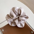Champagne silk scrunchie with soft pleats on a leather background for a chic hairstyle - Beige Coffee