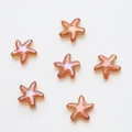 Detailed view of orange starfish glass beads with white spots for DIY jewelry making - Pack of 30 / Wine Red Plated
