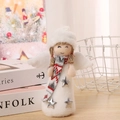 Detailed view of a plush white angel doll with yarn hat and star dress on a wooden table - Angel with Grey Scarf and White Hat