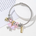 Detail of beaded charm bracelet with pink crystals and golden handmade pendant - Macaron Pink