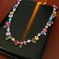 Detail of colorful gemstone necklace with silver chain on black textured display surface - Necklace-Multicolor