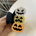 Close-up of three-layered Halloween pumpkin hair claw clip in orange and yellow colors - Pumpkin Stack