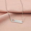Macro view of silver hollow heart pendant necklace on pink silk fabric background - Hollow Heart Style (MP387-6) / Steel
