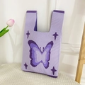 Knitted purple tote bag featuring a beautiful layered butterfly pattern and star accents - Purple Butterfly Bag