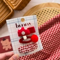 Detail view of handmade red and white fabric bow hair clips and mushroom hair ties - Red Mushroom & Pom Pom Set 3Pcs