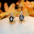 Golden turtle stud earrings featuring an oval black gemstone and sparkling white crystals - Gold Plated Black Zircon