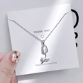 Macro view of a silver tulip pendant with white shell and sparkling rhinestones - 1120 Tulip Cat Eye Stone Necklace