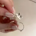 Elegant silver butterfly ring with layered wings and matte finish on a woman's hand - Double Butterfly Ring