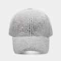 Close-up of gray faux mink fur texture on a warm winter baseball cap with curved brim - Gray