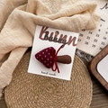 Cute mushroom hair clip in dark red fabric with white dots and a bow on display card - Polka Dot Mushroom Hair Clip