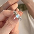 Silver textured ring with rainbow oval opal stone shown on model's finger - No. 31 Open Ring
