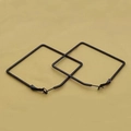 Detail of large black square hoop earrings featuring a matte metallic finish - 55mm / Black