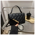 Detail of black quilted PU leather shoulder bag with gold hardware and elegant hand strap - Black