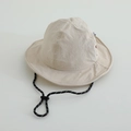Detail view of beige quick-dry bucket hat featuring adjustable drawstring and wide brim - 52cm / Off White