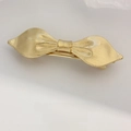 Elegant gold bow hair clip with textured metallic finish and secure spring clamp - Gold Ribbed Bowtie Clip