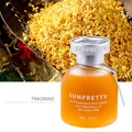 Close-up of SUNPRETTY frosted glass bottle with osmanthus liquid and silver logo cap - 65ml / Fragrans