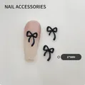 Matte black bow ribbon nail art charms 6x9mm size on soft pink glitter gradient nails - Small Black