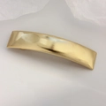 Ribbed gold rectangular hair clip with a modern curved design for daily wear styling - Gold Arched Ribbed Clip