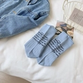 Light blue mid-calf cotton socks featuring black text print in a ribbed knit style - Blue